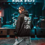 Raverge men's black hoodie Distortion worn by model backside rock streetwear style