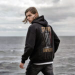Raverge men's black hoodie Storm Bringer worn by model backside Poseidon graphic streetwear style