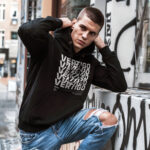 Raverge men's black hoodie Vertigo worn by model spinning typography bold streetwear look