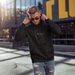 Raverge men's black hoodie New Dimension worn by model abstract geometric futuristic design