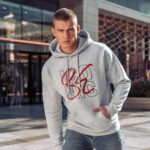 Raverge men's white hoodie Be Iconic worn by model bold typography confident streetwear style