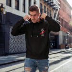 Model wearing Raverge Bushido men's black hoodie with Japanese 'Bushido' script.