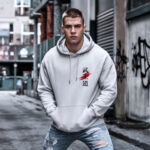 Model wearing Raverge Bushido men's white hoodie with Japanese 'Bushido' script.