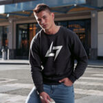 Model wearing men’s Raverge black sweatshirt with minimalist Raverge logo design