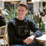 Model wearing the Raverge black Think Without the Box sweatshirt with unique typography design