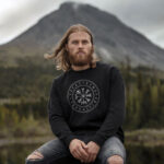 Model wearing Raverge men's Vegvisir black sweatshirt with Viking compass and runes