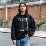 Man wearing Raverge men's Next Generation black sweatshirt featuring futuristic sci-fi graphics.