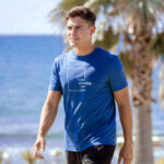 Model showcasing a blue streetwear t-shirt with a "Think Without the Box" graphic design, perfect for creative thinkers.