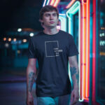 Model showcasing a navy streetwear t-shirt with a "Think Without the Box" graphic design, perfect for creative thinkers.