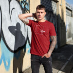 Model showcasing a red streetwear t-shirt with a "Think Without the Box" graphic design, perfect for creative thinkers.