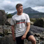 Male model showcasing Raverge's 'Shatter The Limits' white t-shirt