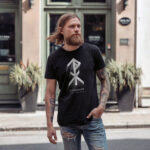 Model wearing Einherjar t-shirt with Viking rune and Elder Futhark text design