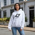 Model wearing Raverge women's white hoodie with the Raverge logo on the chest.