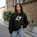 Woman wearing Raverge women's black sweatshirt with Raverge logo.