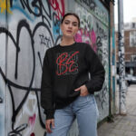 Model wearing Raverge Be Iconic black sweatshirt - Bold fashion statement