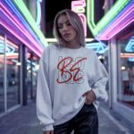 Model wearing Raverge Be Iconic white sweatshirt - Bold fashion statement