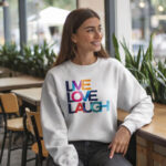 Model wearing Raverge Live Love Laugh women's white sweatshirt with vibrant design
