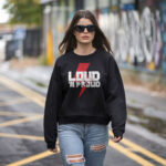 Model wearing Raverge 'Loud 'N Proud' women's black sweatshirt with bold, rocker-style lettering.