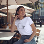 Model wearing white Raverge women's Think Without the Box t-Shirt with bold typography design