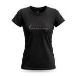 Model wearing black Raverge Embrace Harmony Women's T-Shirt in white with elegant script typography.