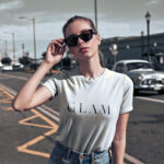 Woman wearing white Glam Girl t-shirt with stylish bold typography
