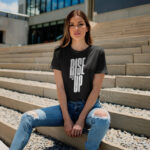 Model wearing women's Rise Up black t-shirt with bold typography and ‘No matter what’ message
