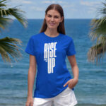 Model wearing women's Rise Up blue t-shirt with bold typography and ‘No matter what’ message