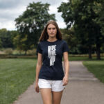 Model wearing women's Rise Up navy t-shirt with bold typography and ‘No matter what’ message