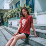 Model wearing women's Rise Up red t-shirt with bold typography and ‘No matter what’ message