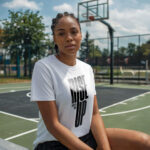 Model wearing women's Rise Up white t-shirt with bold typography and ‘No matter what’ message