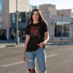 Model wearing Women’s Be Iconic black t-shirt with bold typography design
