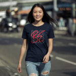 Model wearing Women’s Be Iconic navy t-shirt with bold typography design
