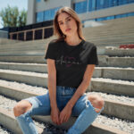 Model wearing Women’s Amour black t-shirt with elegant typography and heart design