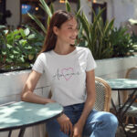 Model wearing Women’s Amour white t-shirt with elegant typography and heart design