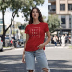 Model wearing Women’s Deny Ordinary red t-shirt with bold Raverge slogan