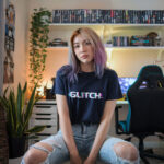 Model wearing Women’s Glitch navy t-shirt with glitch-effect text design