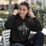 Model wearing the Raverge women's black hoodie titled Black Rose, showcasing a bold and elegant rose design.