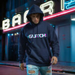 Model wearing Raverge men's navy hoodie Glitch design digital distortion effect tech-inspired streetwear