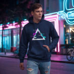 Model wearing Raverge Apex men's navy hoodie with glitched triangle graphic for gamers and sci-fi fans.