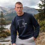 Model wearing the Raverge navy Think Without the Box sweatshirt with unique typography design