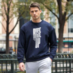 Model wearing Raverge men's Rise Up navy sweatshirt with bold text design