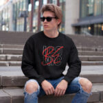 Model wearing Raverge men's Be Iconic black sweatshirt with bold text design