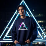 Man wearing Raverge men's Apex navy sweatshirt featuring a glitched triangle graphic.