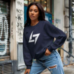 Woman wearing Raverge women's navy sweatshirt with Raverge logo.